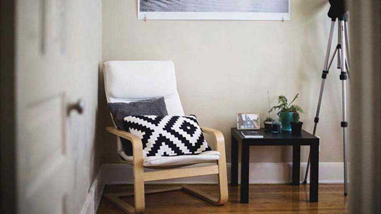 Entrance of an apartment with furniture and a camera tripod, all covered by the tenant's renters insurance.